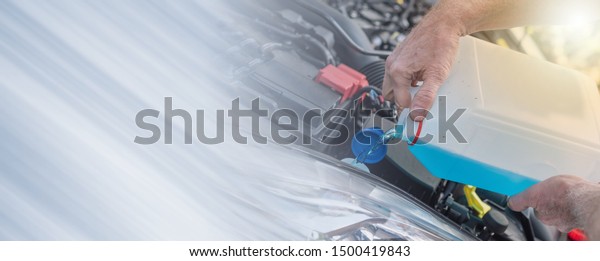 Hands of mechanic pouring windscreen washer in a\
car; multiple exposure