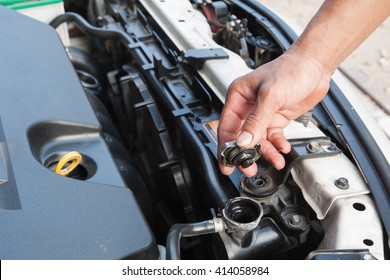 Hands Of Mechanic Working In Auto Repair Shop; Check The Car Radiator