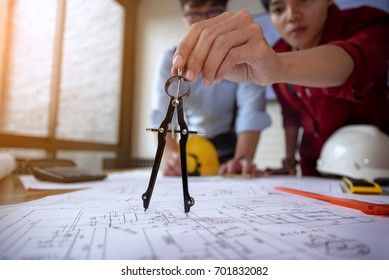 Hands Of A Mechanical Engineer Are Holding A Compasses For Writing To Work. Engineering Tools And Construction Concept.