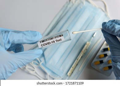 Hands In Medical Gloves Holding COVID-19 Swab. Test Tube For Taking Patient Sample, PCR DNA Testing Protocol Process. Nasal Swab Laboratory Test In Hospital Lab.