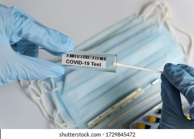 Hands In Medical Gloves Holding COVID-19 Swab. Test Tube For Taking Patient Sample, PCR DNA Testing Protocol Process. Nasal Swab Laboratory Test In Hospital Lab.