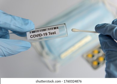 Hands In Medical Gloves Holding COVID-19 Swab. Test Tube For Taking Patient Sample, PCR DNA Testing Protocol Process. Nasal Swab Laboratory Test In Hospital Lab.