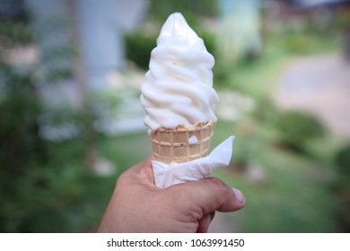 The hands of men holding ice cream. - Shutterstock ID 1063991450