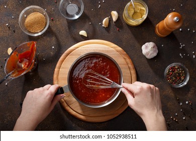 Hands Mix The Bbq Sauce With The Whisk In The Saucepan. Step By Step Recipe Of Homemade Bbq Wings Top View.