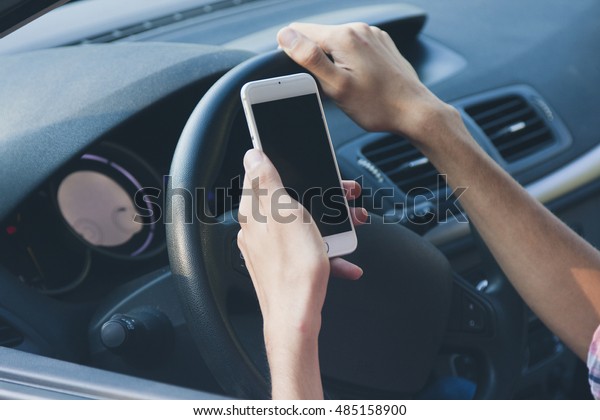 hands with mobile phone\
driving