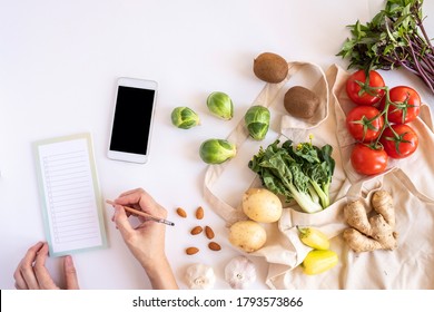 Hands And Mobile Phone For Searching Online App For Recipe , Nutrition, Diet And Grocery Shopping.