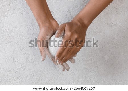 Hands modeling clay plaster, handmade work, light textured background