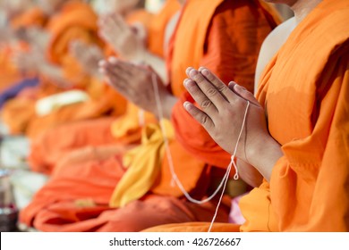 Hands of a monk praying to blessed bride and groom in Thai's wedding religion ceremony.