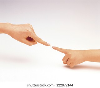 Hands Of Mother And Child Touching By Index Finger