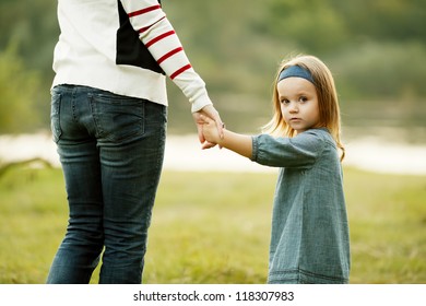 Hands Of Mother And Daughter Holding Each Other.