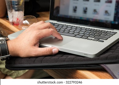 Hands multitasking man using laptop.
