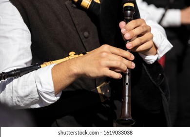 Hands Of A Musician Playing A Bagpipe In A Festive Parade. Galicia, Spain