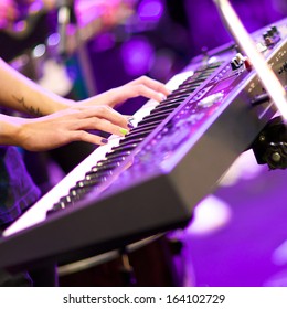 hands of musician playing keyboard in concert with shallow depth of field, focus on right hand - Shutterstock ID 164102729