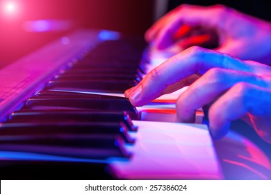 hands of musician playing keyboard in concert with shallow depth of field - Powered by Shutterstock