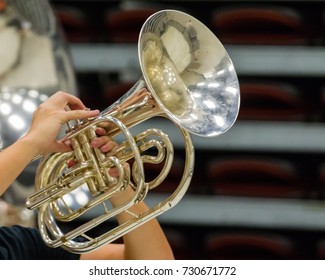 The Hands Of A Musician Playing A Mellophone