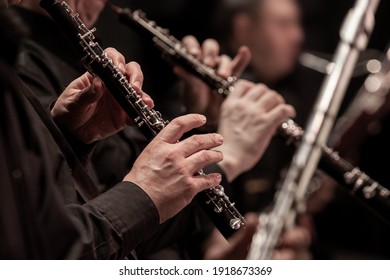 Hands of a musician playing the oboe in an orchestra 
