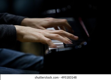 Hands musician playing the piano closeup