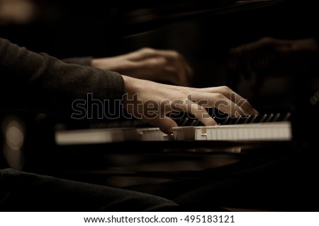 Hands musician playing the piano closeup