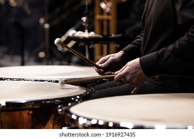  Hands of a musician playing the timpani in the orchestra close up
