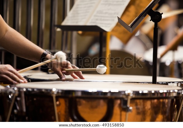 Hands musician playing the timpani in the\
orchestra closeup