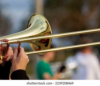 hands of a musician playing a trombone at rehearsal - Powered by Shutterstock