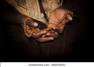 Hands of a Muslim man holding a rosary