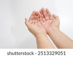 Hands of muslim man praying isolated on white background isolated. two empty man hands open with palms up closeup of top view praying hands.




