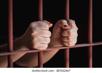 Hands Of Muslim Woman Holding Bars In Jail Selective Focus On Left Hand.