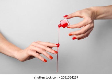 Hands with nail polish on grey background - Shutterstock ID 2081364289