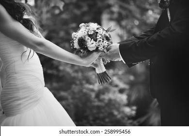 Hands Of Newlywed Couple In Love, Wedding On Summer Day.  Picture In Black And White. 