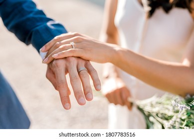 hands of newlyweds with wedding rings close up - Shutterstock ID 1807783516