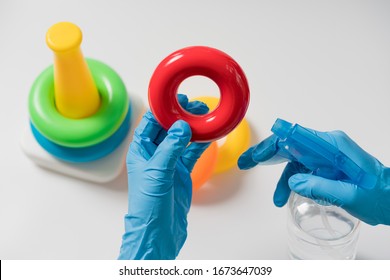 Hands In Nitrile Gloves Are Cleaning And Disinfecting Toys