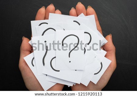 Hands with a note written by a question mark on the background