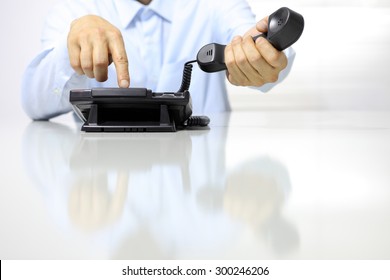 Hands With Office Phone On Desk