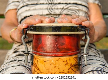 Hands Of Old Lady Playing An African Drum