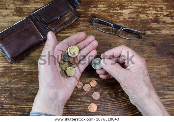 Hands of an old man\
counting money, Euro.  The concept of poverty, austerity, savings\
in old age.