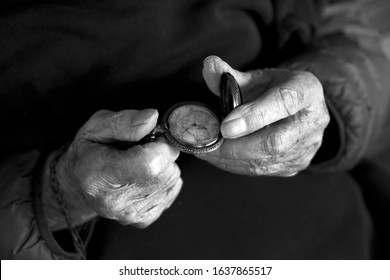 Hands Of An Old Man Holding A Pocket Watch. A Concept Of Time Passages.