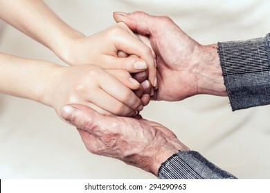 Hands Of The Old Man And A Young Woman. Toning