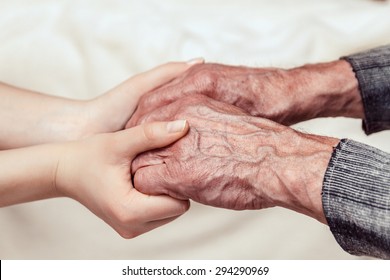 Hands Of The Old Man And A Young Woman. Toning