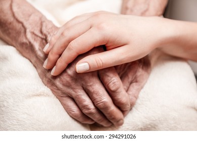 Hands Of The Old Man And A Young Woman. Close Up. Toning