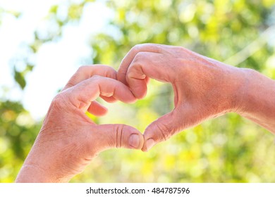 Hands Of Old Senior Showing Heart