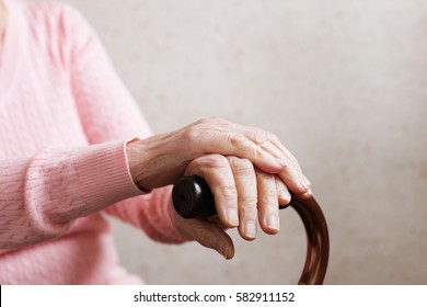 Hands Of An Old Woman With A Cane