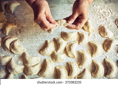 Hands Of An Old Woman Making Pierogies.