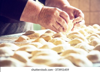 Hands Of An Old Woman Making Pierogies.