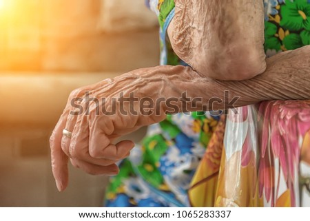 hands of an old woman on the table