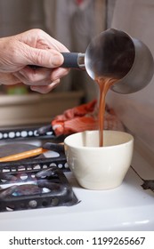 Hands Of Old Woman Serving Coffee On A Cup