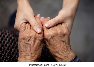 hands of old and young woman	
