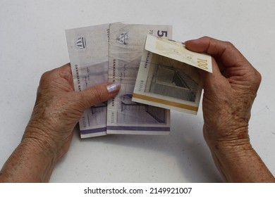 Hands Of An Older Woman Holding And Counting Danish Money