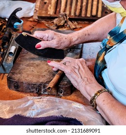 Hands Of Older Woman Making Cuban Cigar From Tobacco Leaves. Travel Concept