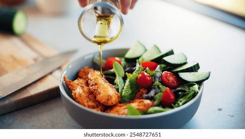 Hands, olive oil and salad in kitchen, home and meal prep with seasoning, meat or flavor with vegetables. Person, chef and bowl with food for nutrition, wellness or gut health with diet at apartment - Powered by Shutterstock